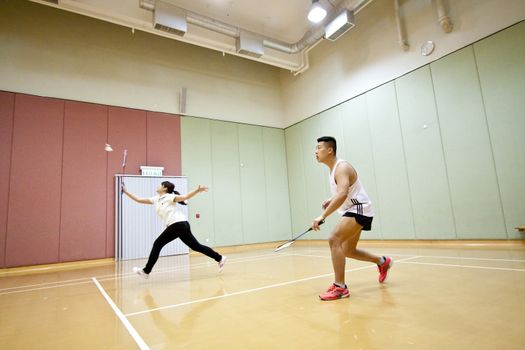 Asian friends playing badminton