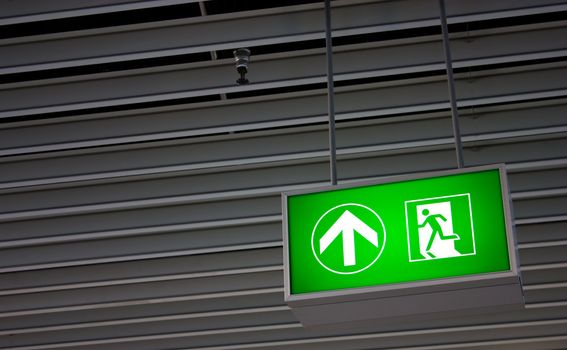 Emergency exit sign in modern offices inside an industrial plant