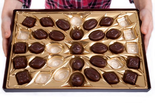 half empty box of chocolates in little girl hands
