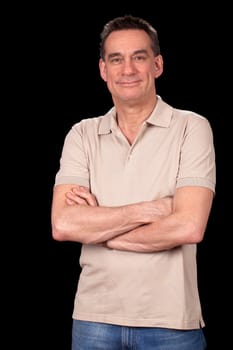Attractive Middle Aged Man in Casual Clothes Standing with Arms Folded on Black