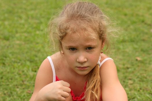 sad girl on grass background