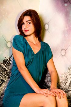 View of a beautiful young girl on a blue dress inside a bar pub.