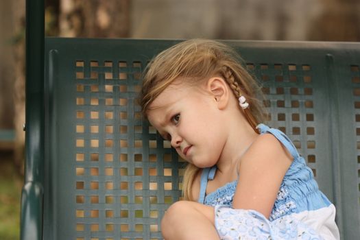 sad little child on a bench