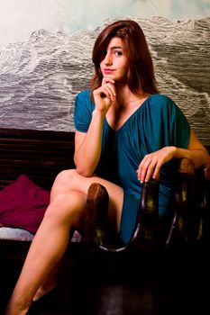 View of a beautiful young girl on a blue dress inside a bar pub.