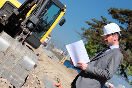 the architect with hardhat on building site