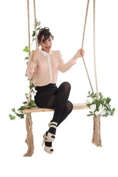 Emotional woman on a swing in the studio isolated background