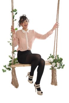 Emotional woman on a swing in the studio isolated background