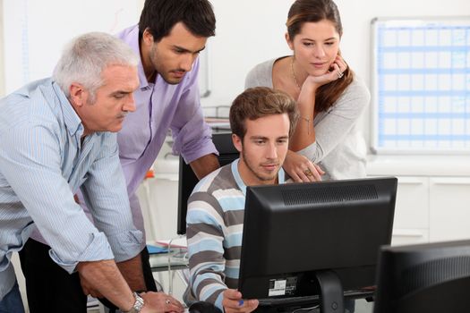 Colleagues looking at computer