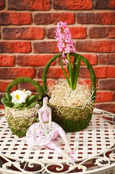 Flowers on a metal shod table against a wall from a red brick