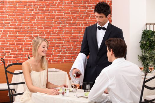 waiter serving couple