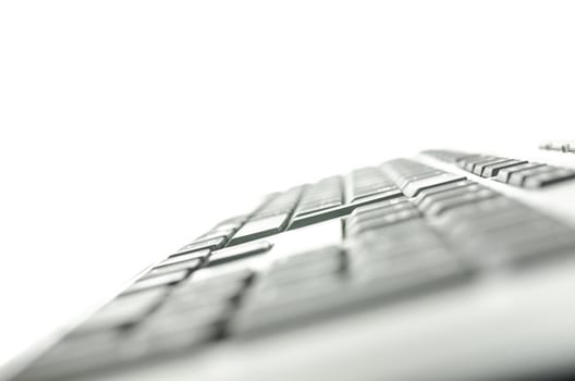 Side view of computer keyboard isolated over white background. Shallow depth of field.