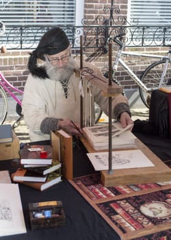 BRIELLE,HOLLAND APRIL 01:Man busy with book binder on April 01, 2013 in Brielle,Holland.This is the party of the point in the uprising of Low Countries against Spain in the 80 Years' War