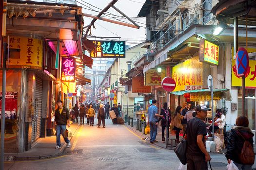 Macau- January 22, 2013: Unidentified people walking on downtown street in Macau. Macau features a strong tourism industry based on gambling and is visited by over 25 million people every year