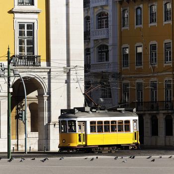 Typical yellow Tram in old street, Lisbon, Portugal 