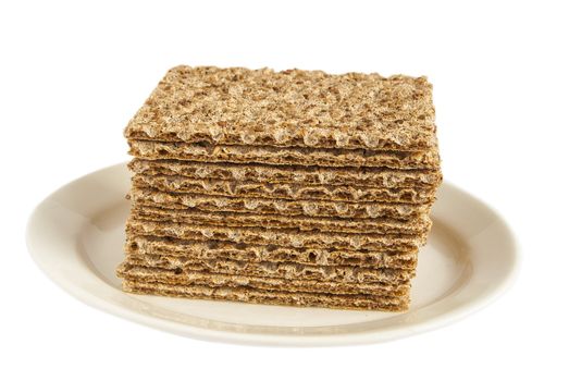 Sesame wholegrain crispbreads on porcelain plate isolated on white background