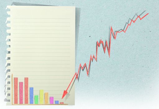 arrow graph going down with staple recycled paper craft stick