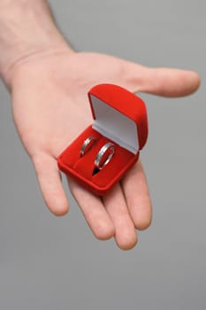 two wedding rings in open box on a hand