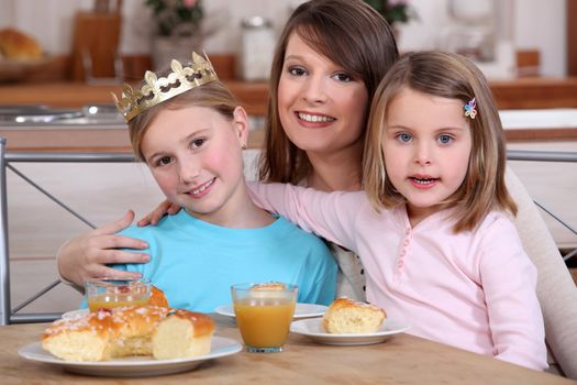 Girls celebrating the Epiphany with a 'Galette des Rois'