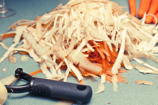 Potato and carrot peelings on a worktop