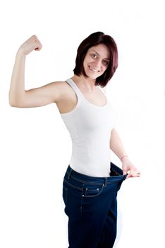 attractive caucasian woman with big jeans on white background, weight loss