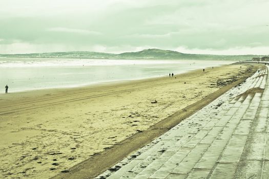 View of aberafan beach in South Wales in winter, with Swansea city on the distance