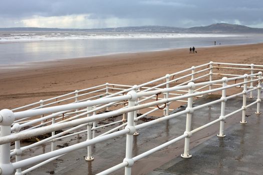view of aberafan beach in South Wales in winter, with Swansea city in the distance
