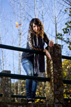 View of a beautiful girl on a urban park on a autumn set.