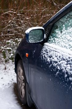 A parked car with snow on it