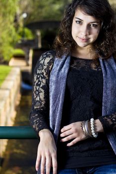 View of a beautiful girl on a urban park on a autumn set.