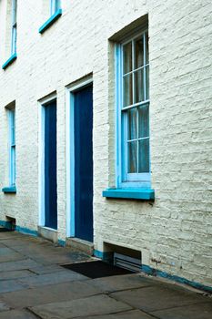 White town houses with blue doors and windows