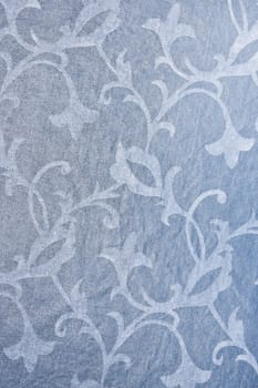 Muted blue textile background with floral pattern