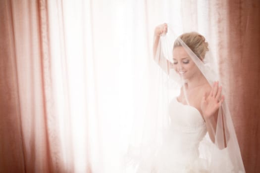 bride playing with flying veil