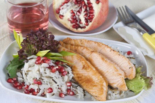 Salmon steak with rice and pomegranate sauce