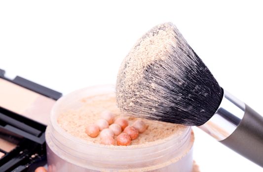 powder with cosmetic brush, on white background