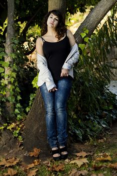 View of a beautiful girl on a urban park on a autumn set.