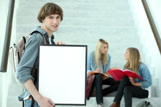 Student holding blank poster