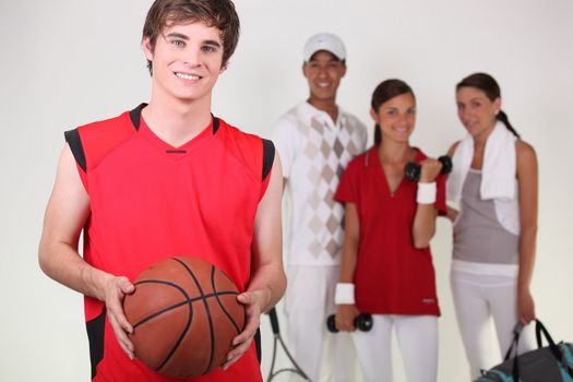 A basketball player posing with other athletes