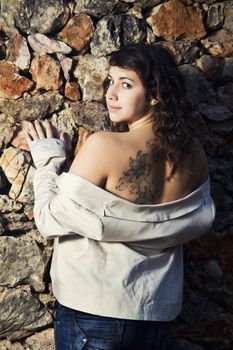 View of a beautiful girl showing her tattoo.