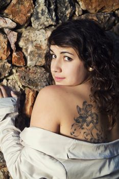 View of a beautiful girl showing her tattoo.