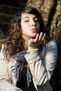 Close view of a beautiful caucasian girl sending an airkiss.