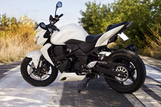 View of a high speed motorcycle on a asphalt road.