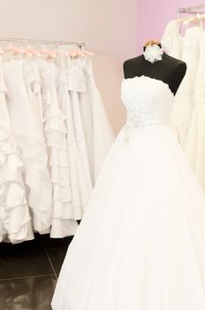 Wedding store background. White bridal dresses. Shallow depth of field