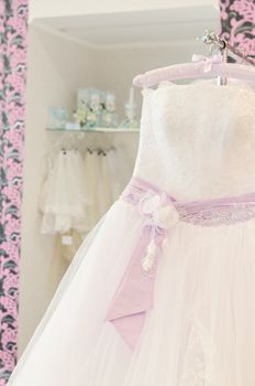 Wedding store background. White bridal dresses. Shallow depth of field