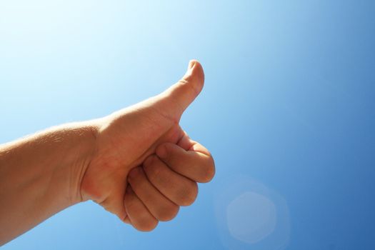 men's hand make thumbs up on blue sky