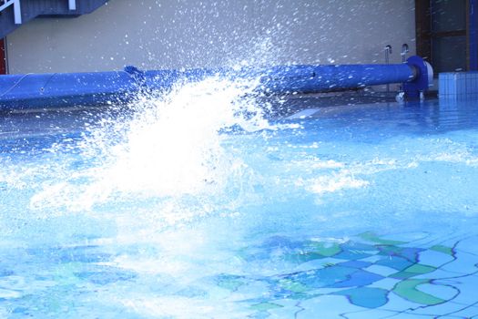 man swims in swimming pool