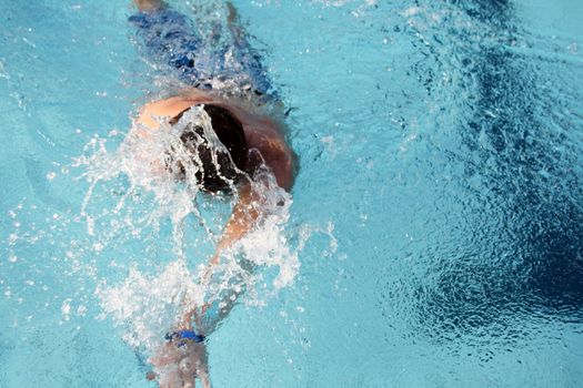 man swims in swimming pool