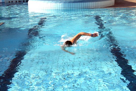 man swims in swimming pool