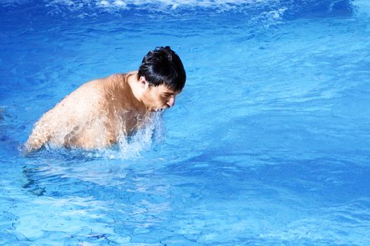 man swims in swimming pool