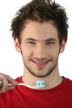 Young man holding a toothbrush