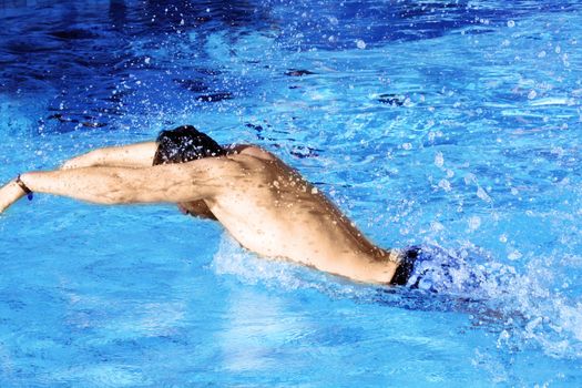 man swims in swimming pool